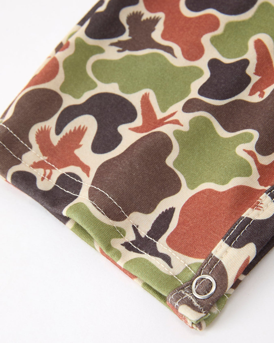 Camouflage-patterned fabric with birds on a white background