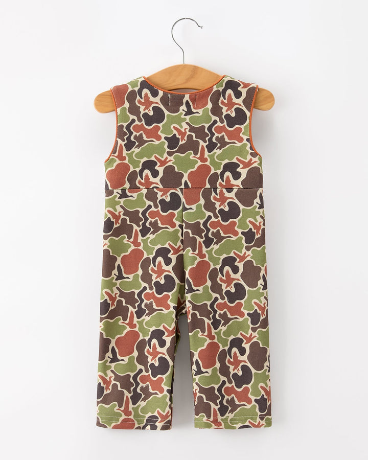 Camouflage-patterned overalls on a hanger against a white background
