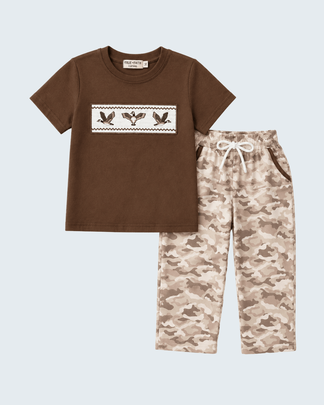 Brown t-shirt with duck design and camouflage pants on a light blue background