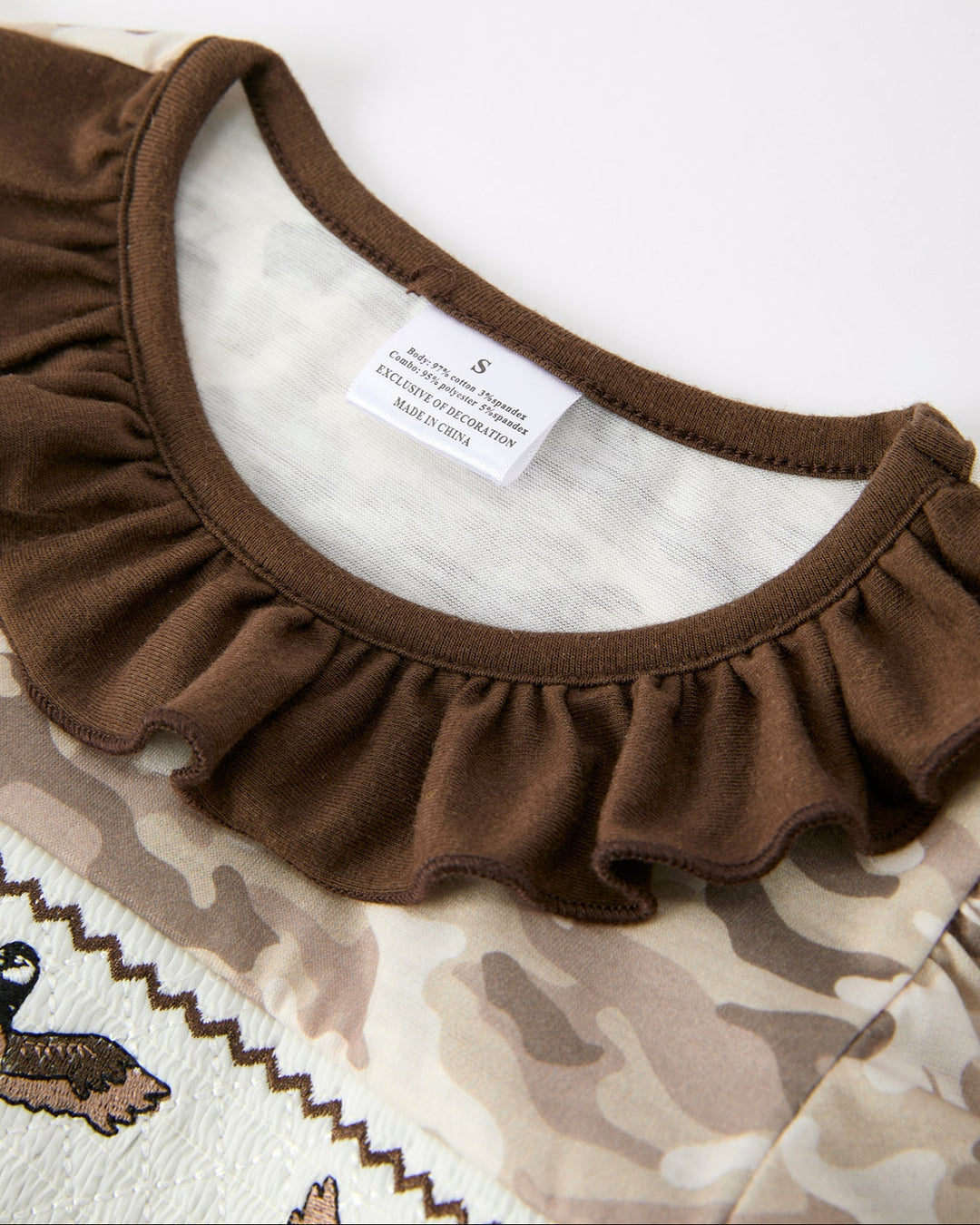 Close-up of a brown ruffled collar on a white background