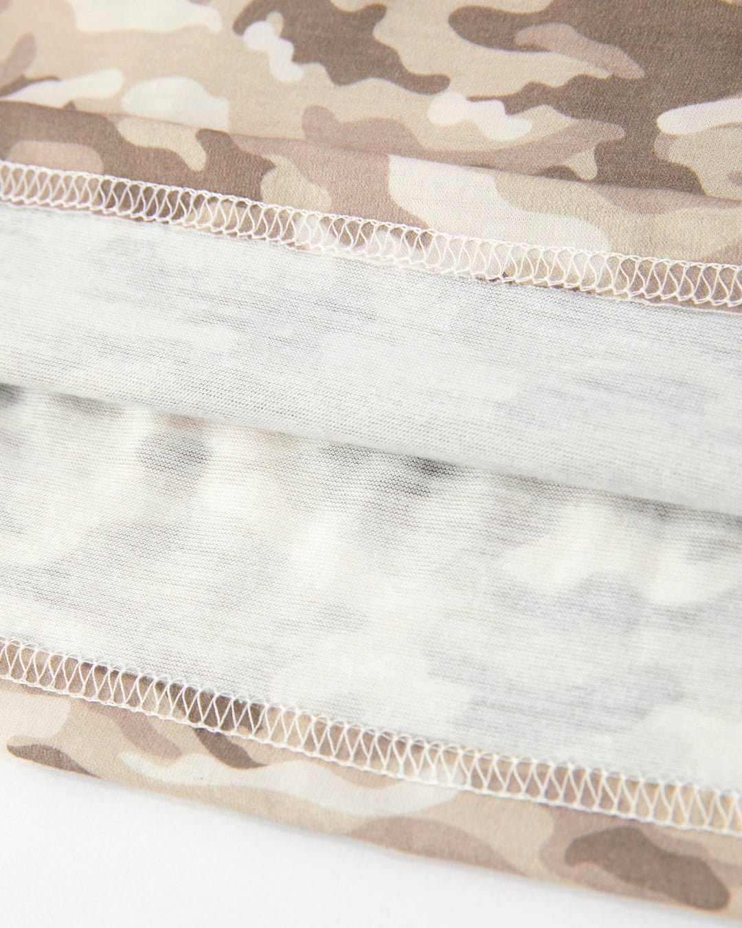 Close-up of camouflage fabric with a white mesh layer underneath