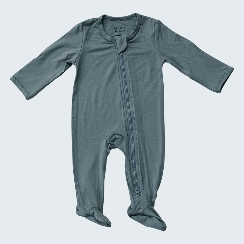 Blue baby onesie with a zipper on a light gray background