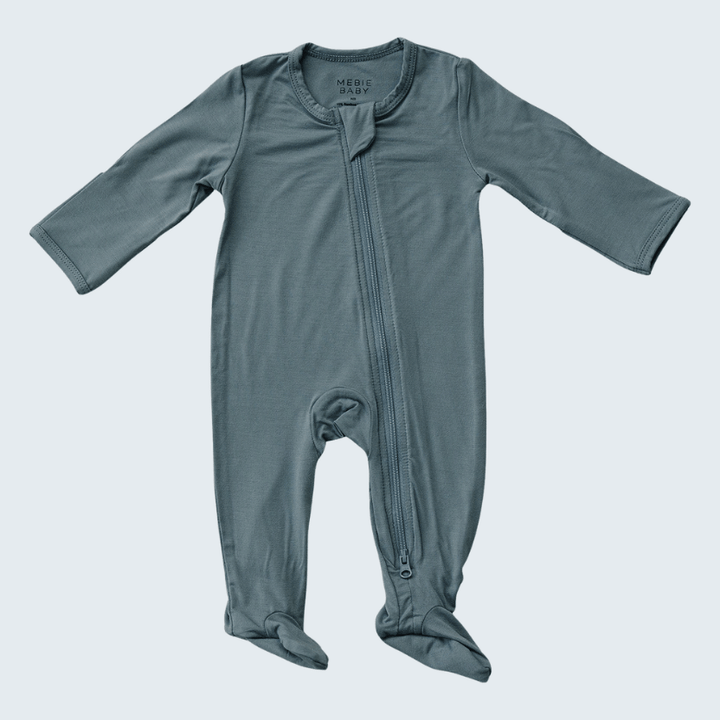 Blue baby onesie with a zipper on a light gray background