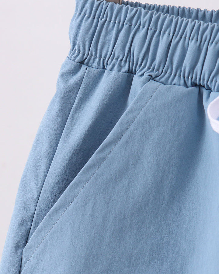 Dusty blue shorts with gathered elastic waistband and side seam pleats