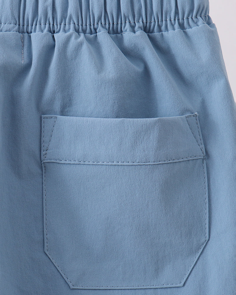 Dusty blue front pocket with stitched edges and elastic waistband