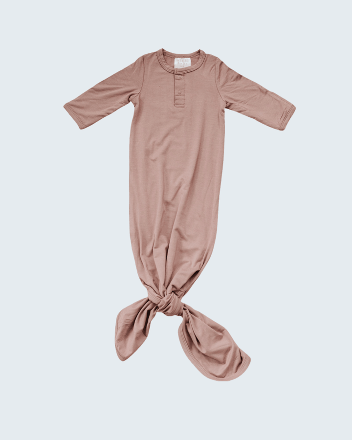Pink baby knot gown on a light gray background