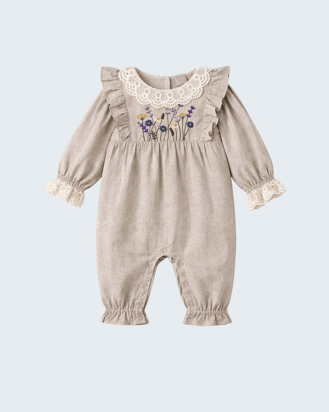 Beige linen long-sleeve romper with embroidered wildflowers and lace neckline trim