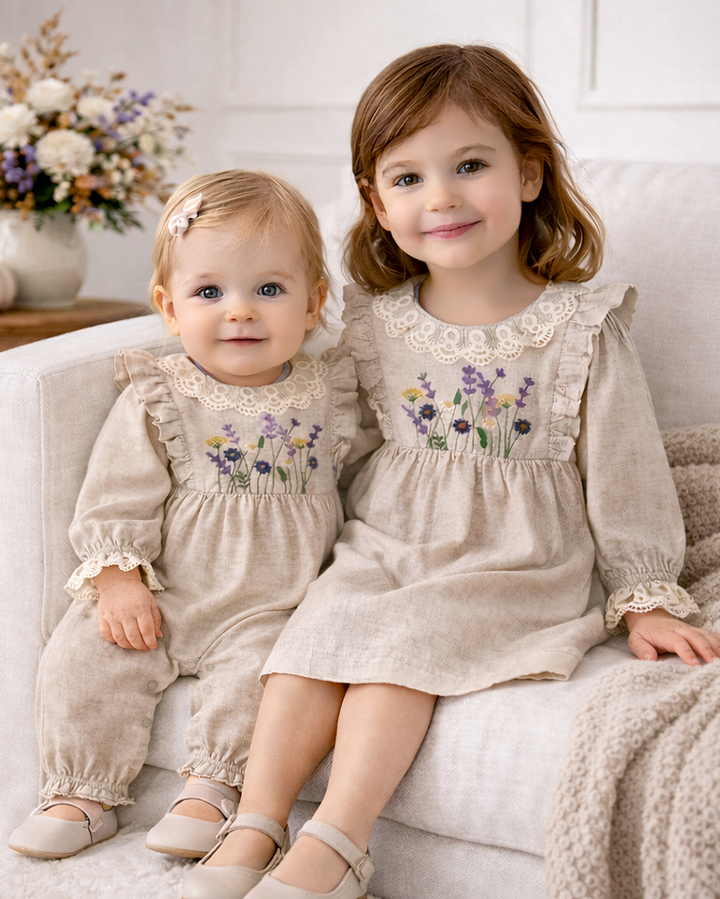 Tan linen romper with wildflower embroidery and lace yoke, long puff sleeves