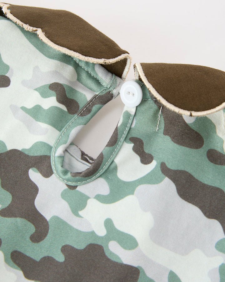 Camo dress closeup with brown collar, button placket, and flutter sleeve edging