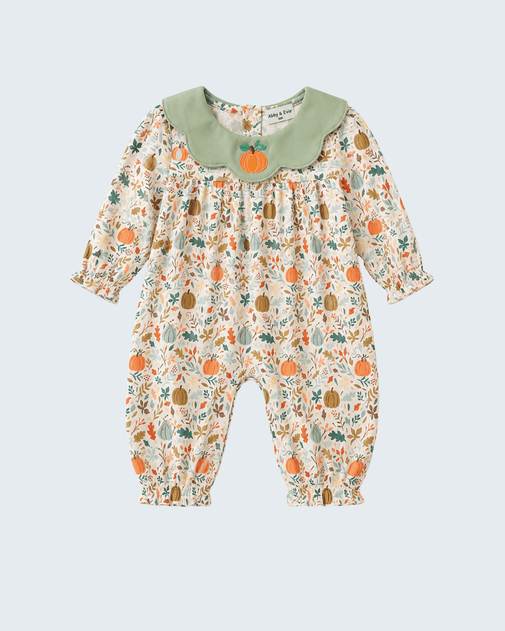 A baby long-sleeve romper with a cream base, an all-over autumn pumpkin and leaf print, and a contrasting sage green Peter Pan collar featuring a small embroidered orange pumpkin.