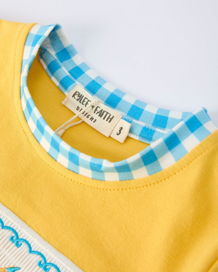 Yellow garment with blue checkered collar and &