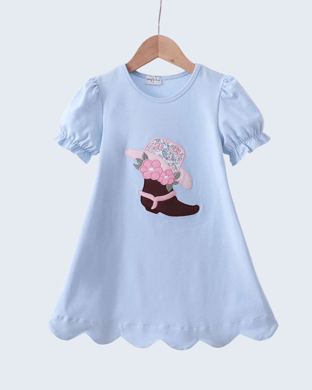 Light blue dress with a floral cowboy boot design on a white background