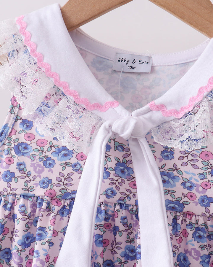 Floral dress with white collar and pink trim on a hanger