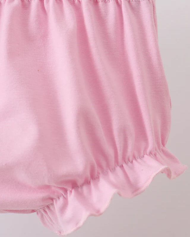 Pink baby bloomers on a light gray background