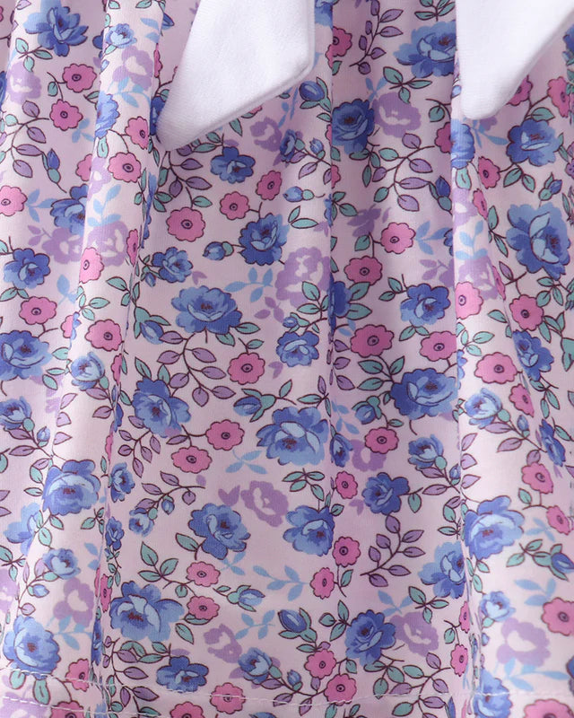 Floral patterned fabric with blue and pink flowers on a white background