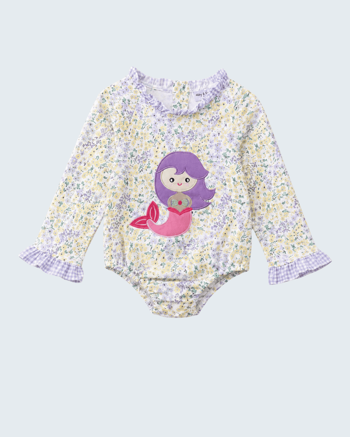 Floral baby rash guard with mermaid design on a light gray background