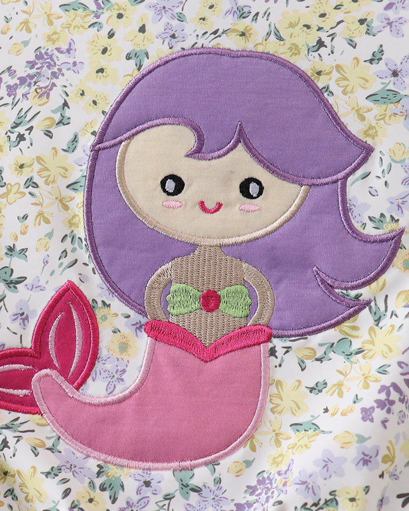 Embroidered mermaid design with purple hair and pink tail on a floral background