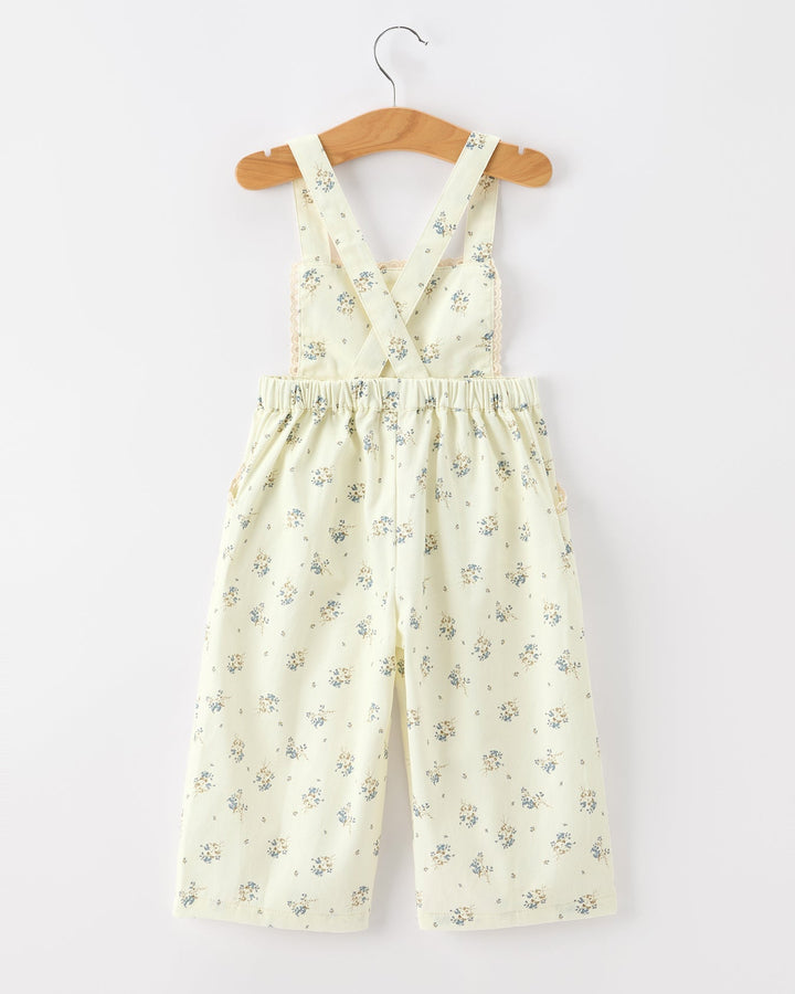 Floral jumpsuit on a hanger against a white background