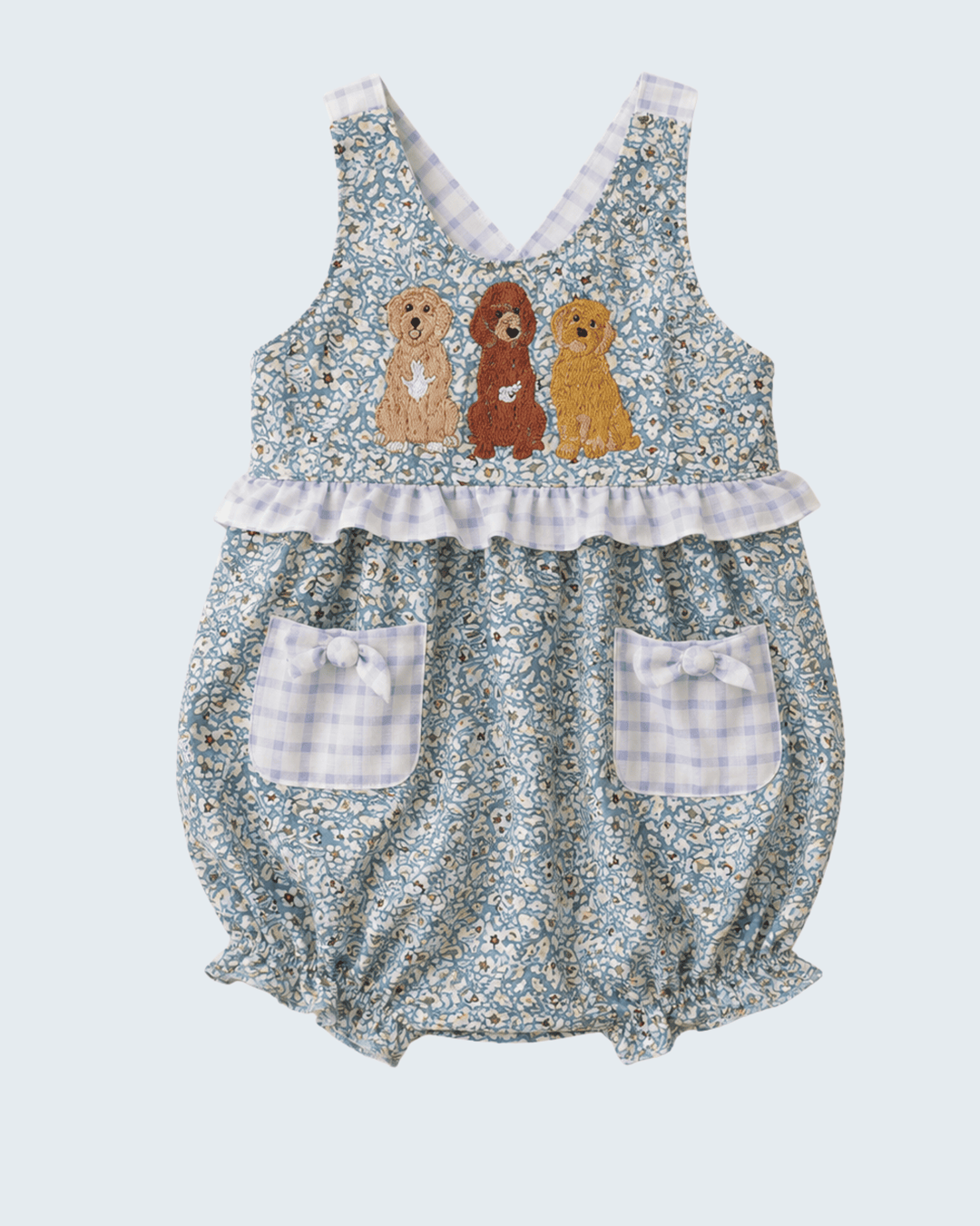 Floral baby romper with embroidered dogs on a light blue background