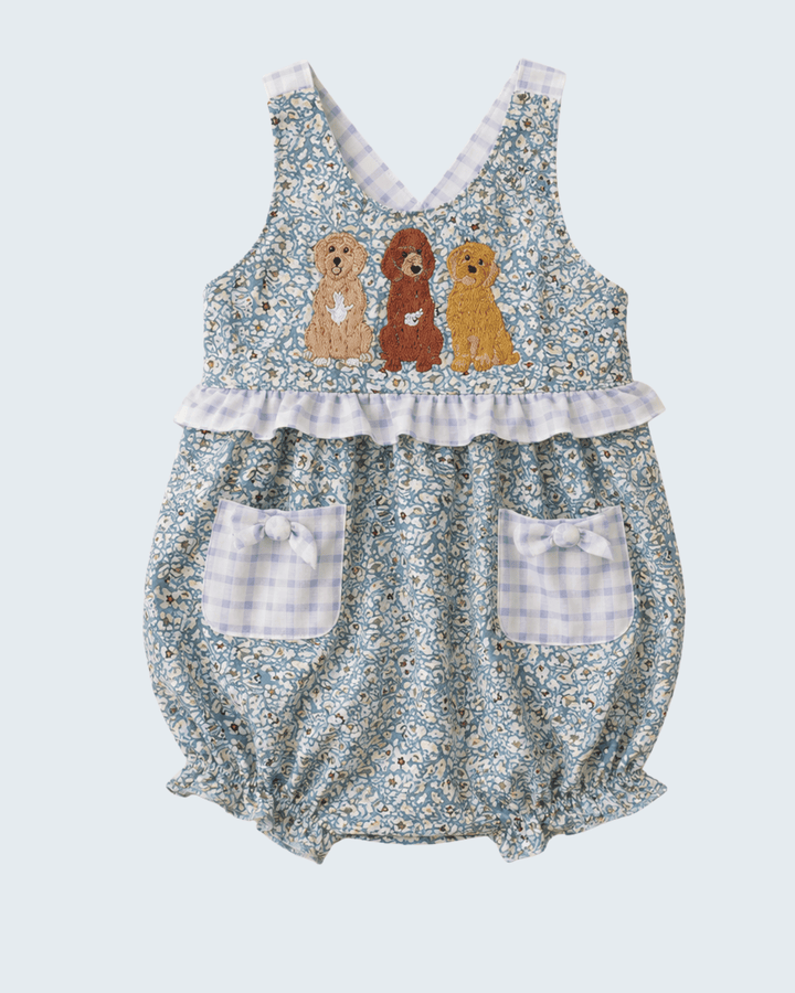 Floral baby romper with embroidered dogs on a light blue background