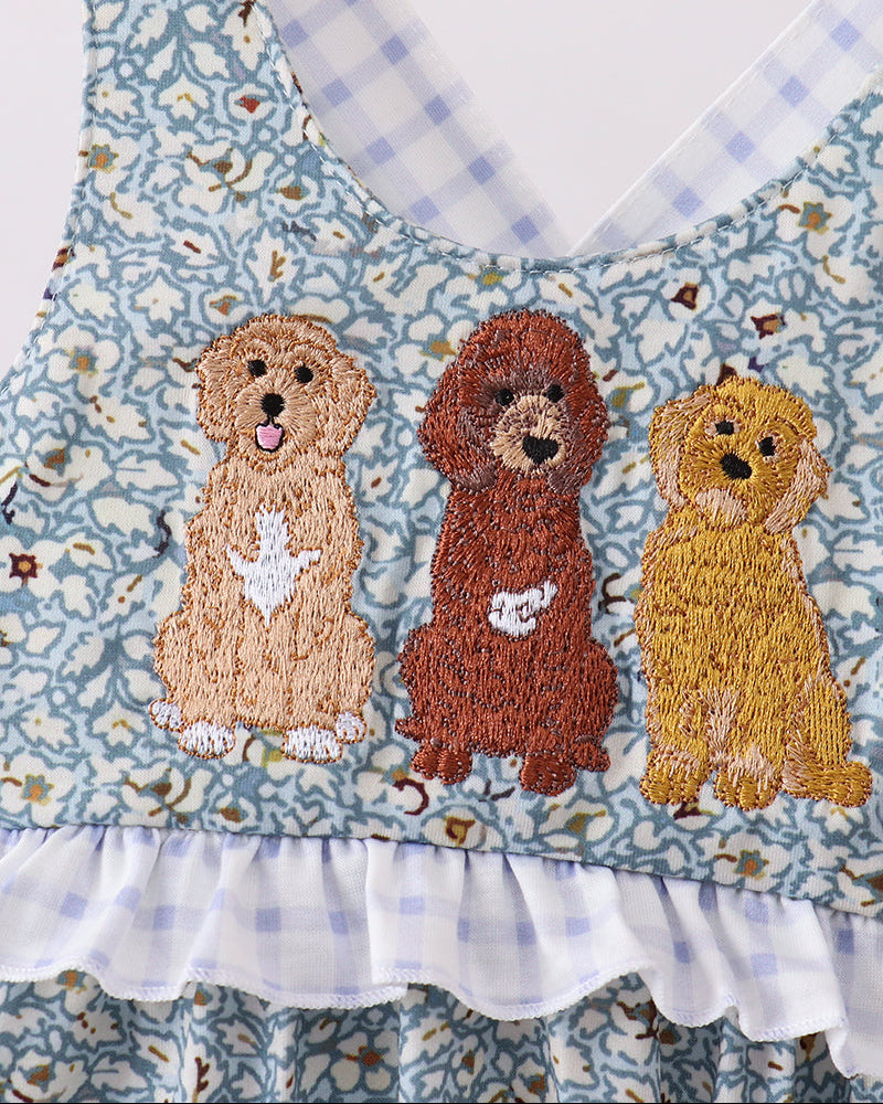 Embroidered romper with three dogs on a floral patterned background