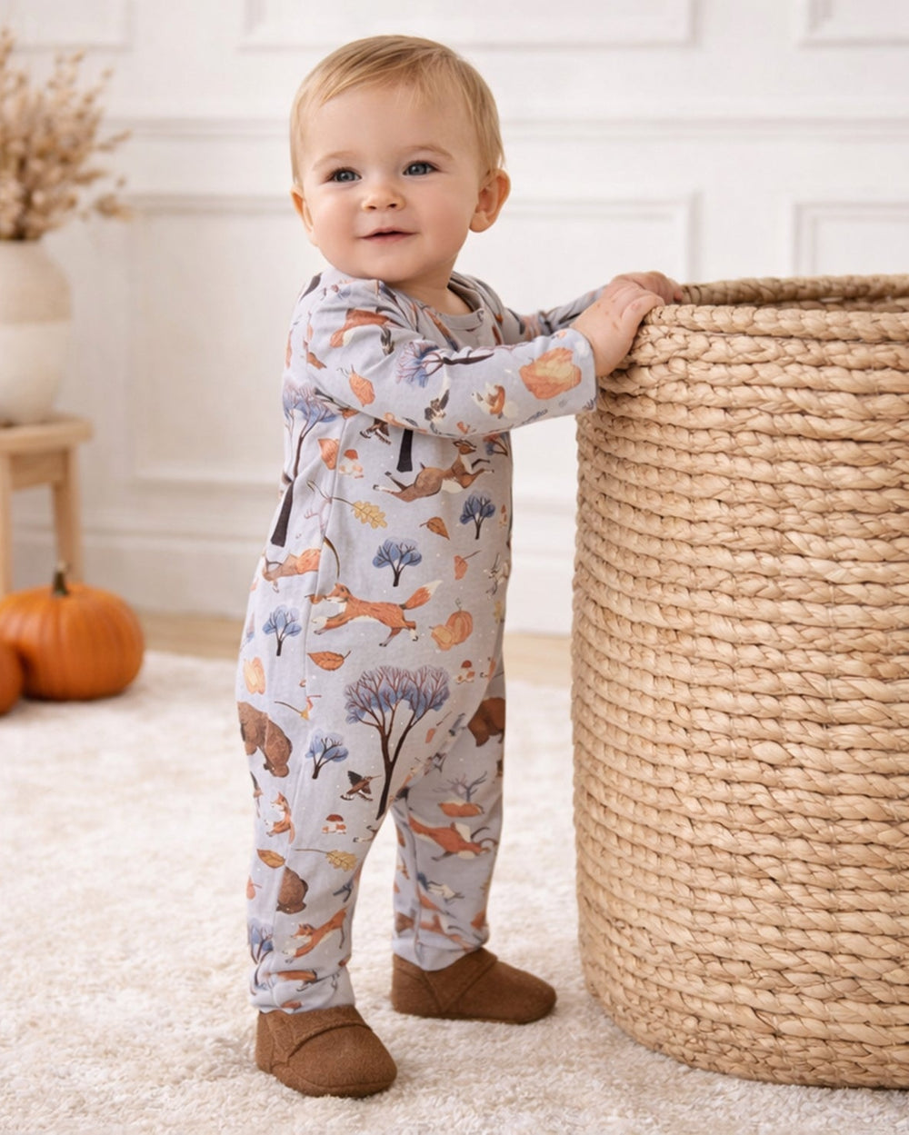 Woodland-print baby footed romper with long sleeves, all-over animal trees pattern