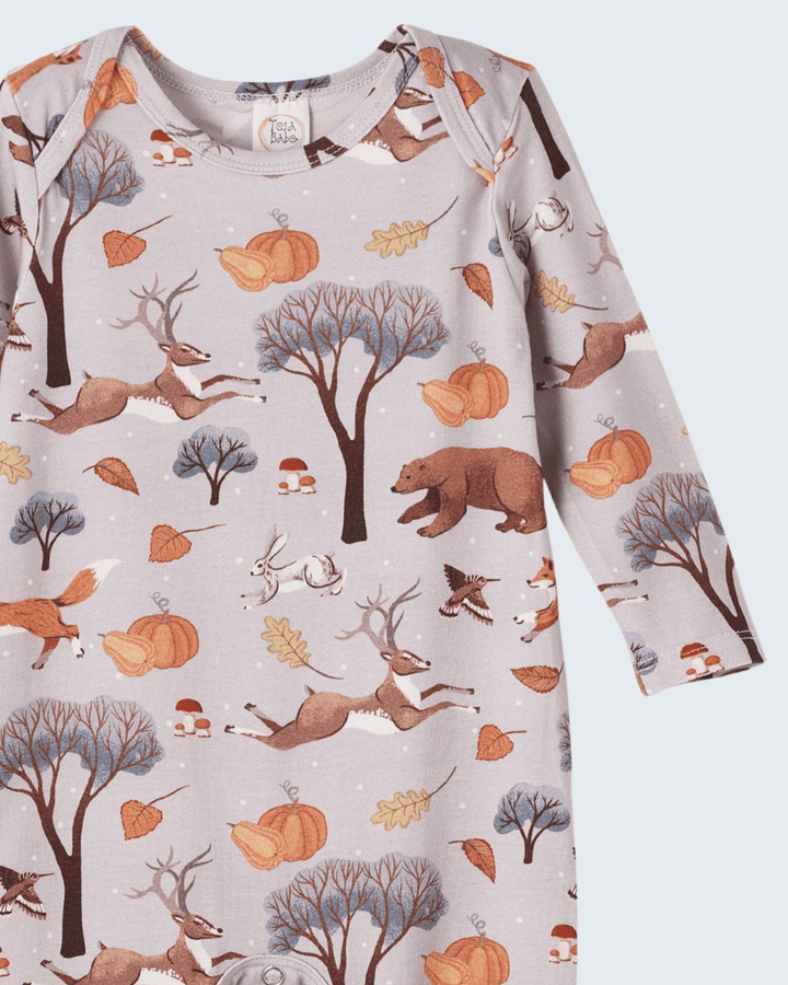 Bamboo romper close-up: crew neck with snaps and forest animal fall print.