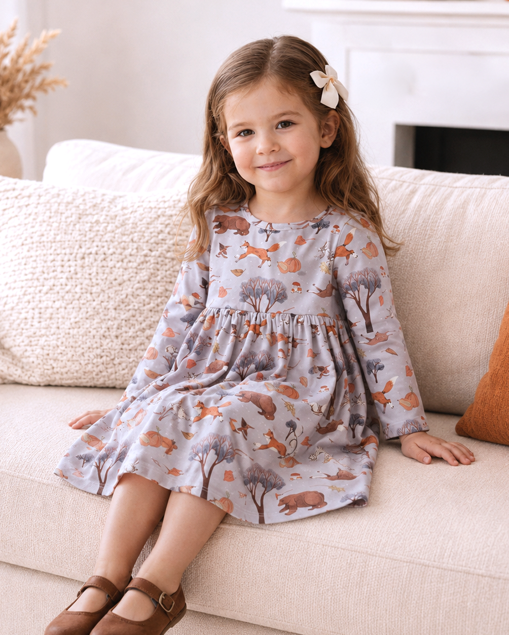 Girls twirl dress with long sleeves, gathered skirt, woodland animal print on light base