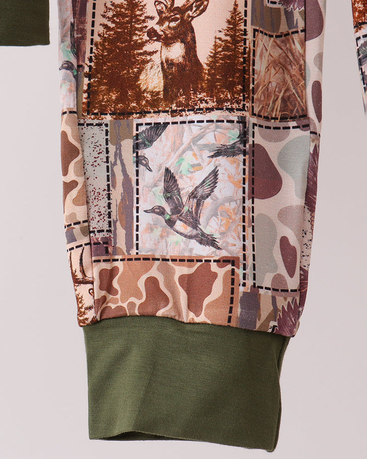 Woodland-print pajama pants with olive hem cuff and stitched patch detail