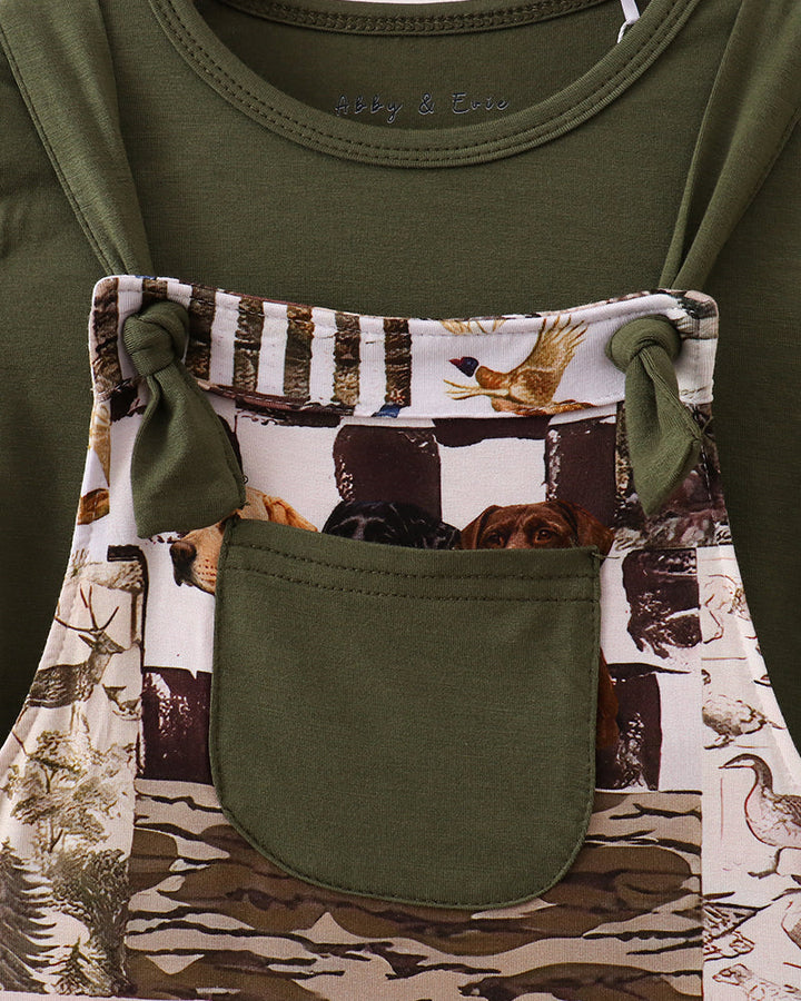 Olive T-shirt with large front patch pocket over woodland animal print overalls