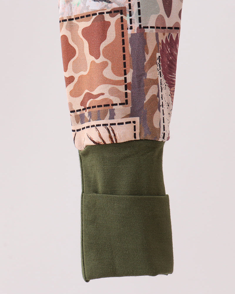 Camouflage romper with olive green lower panel and gathered fabric around the hem