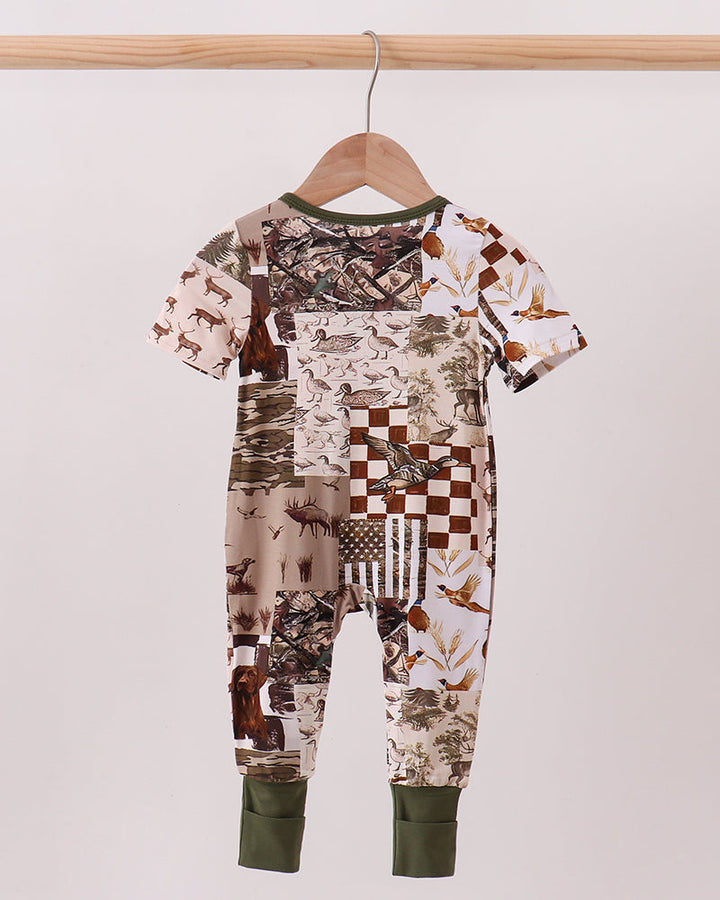 Short-sleeve bamboo romper with multicolor animal print and olive-green cuffs