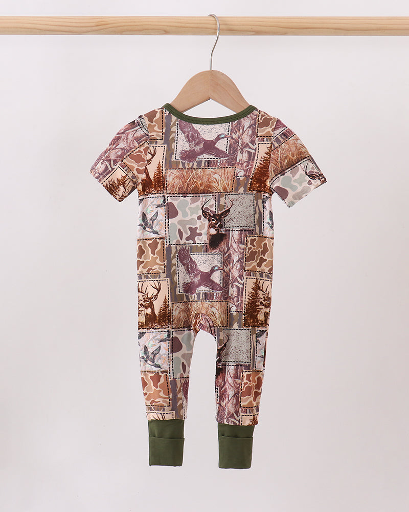Camouflage romper with short sleeves, front zipper, olive green cuffs and pant hems