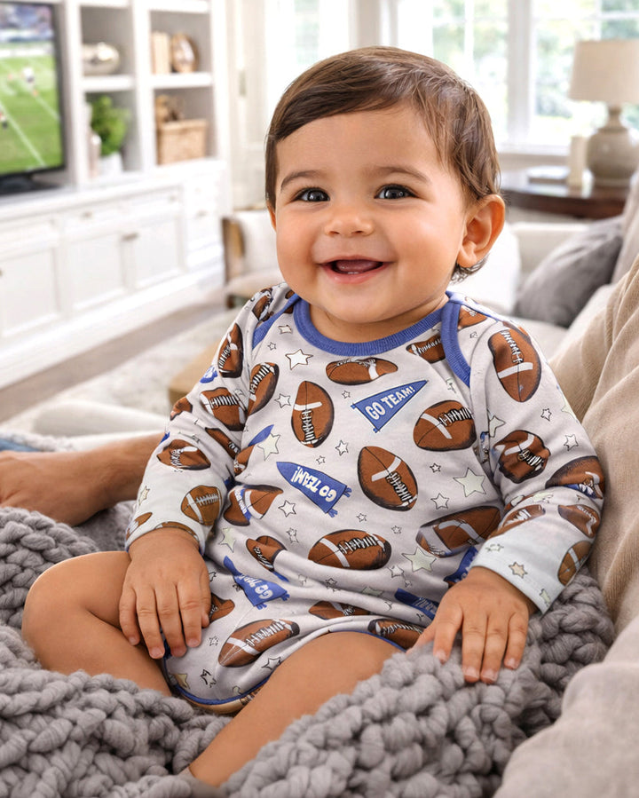 Baby boy long-sleeve bodysuit in light blue with football pattern and star accents