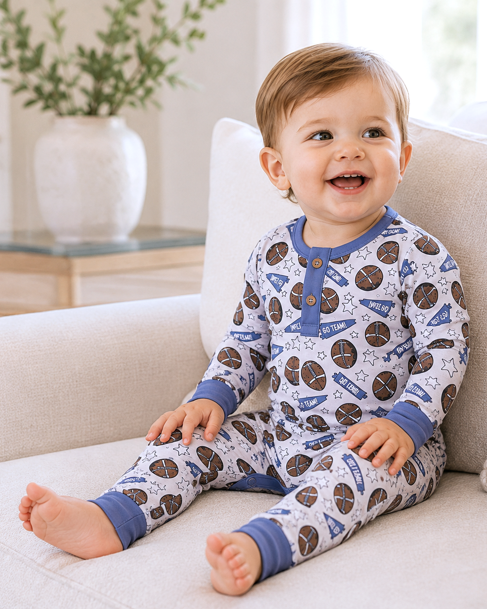 Light blue football-print baby footed romper, long sleeves with snap buttons
