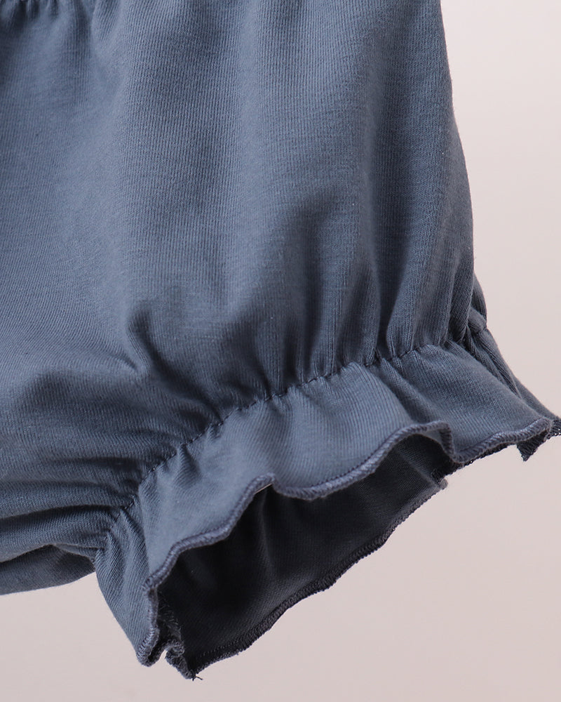 Navy ruffle hem detail on baby bloomer set top with gathered fabric edge
