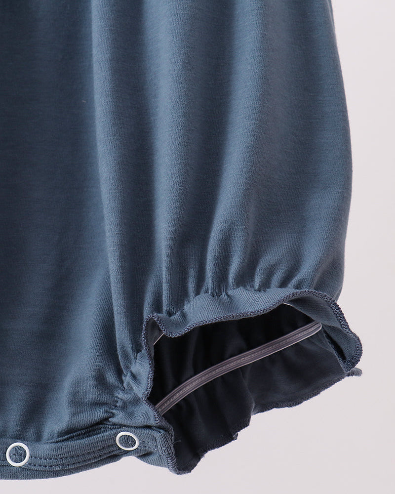 Dark blue bubble romper with scalloped ruffle hem and snap-close leg opening