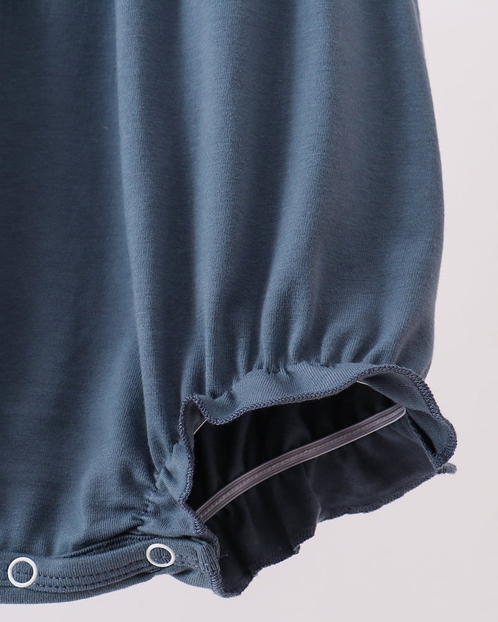 Dark blue bubble romper with scalloped ruffle hem and snap-close leg opening