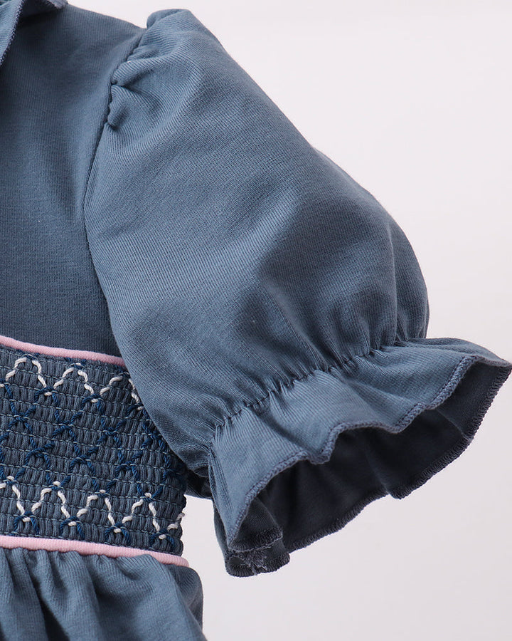 Blue puff sleeve with gathered cuff and dark smocked waist panel