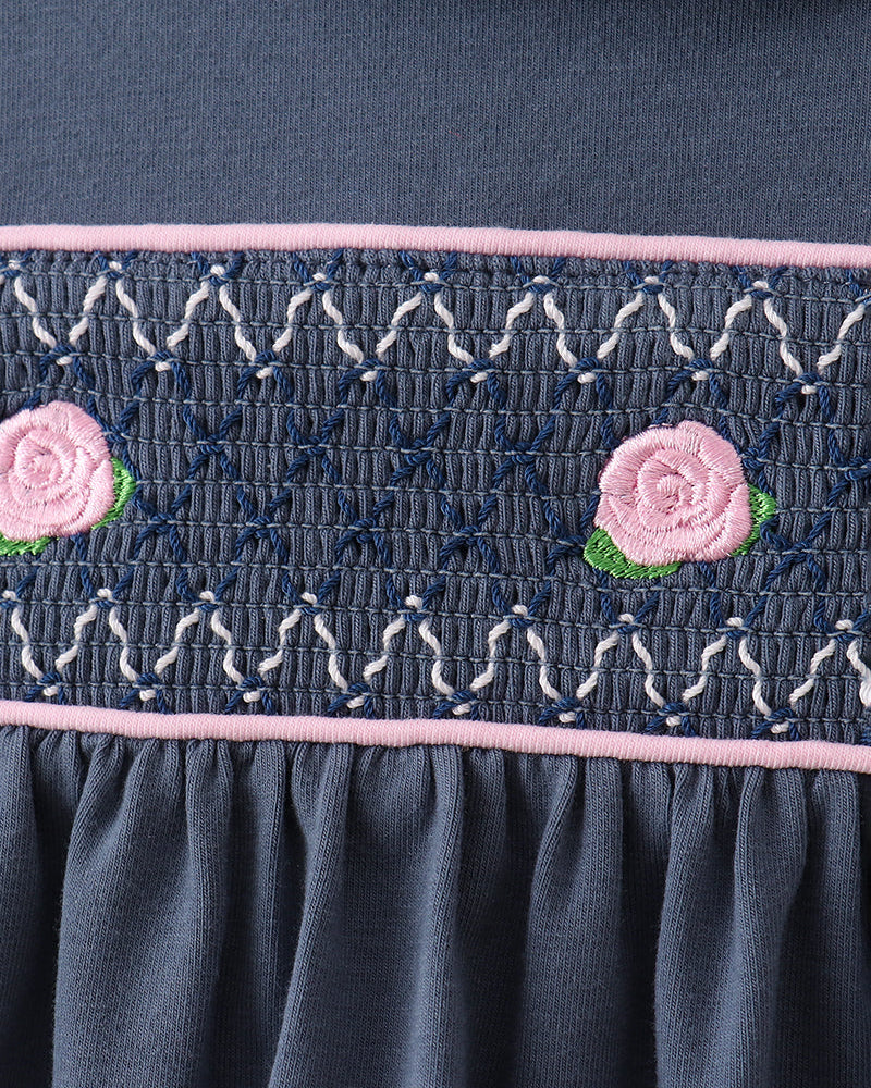 Dark blue smocked waistband with embroidered rose appliques and pink trim