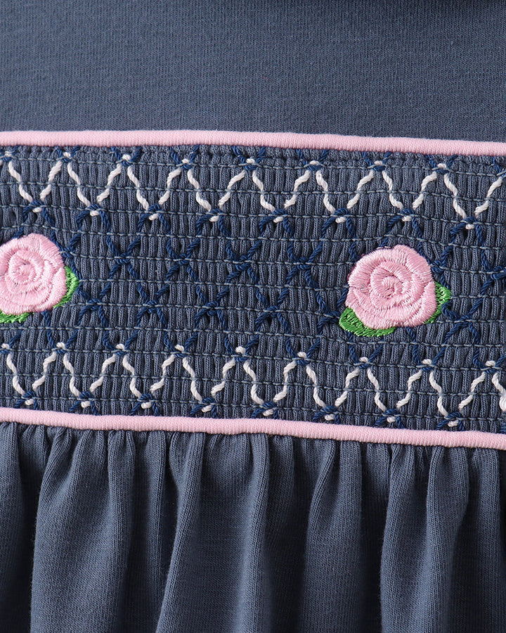 Dark blue smocked waistband with embroidered rose appliques and pink trim