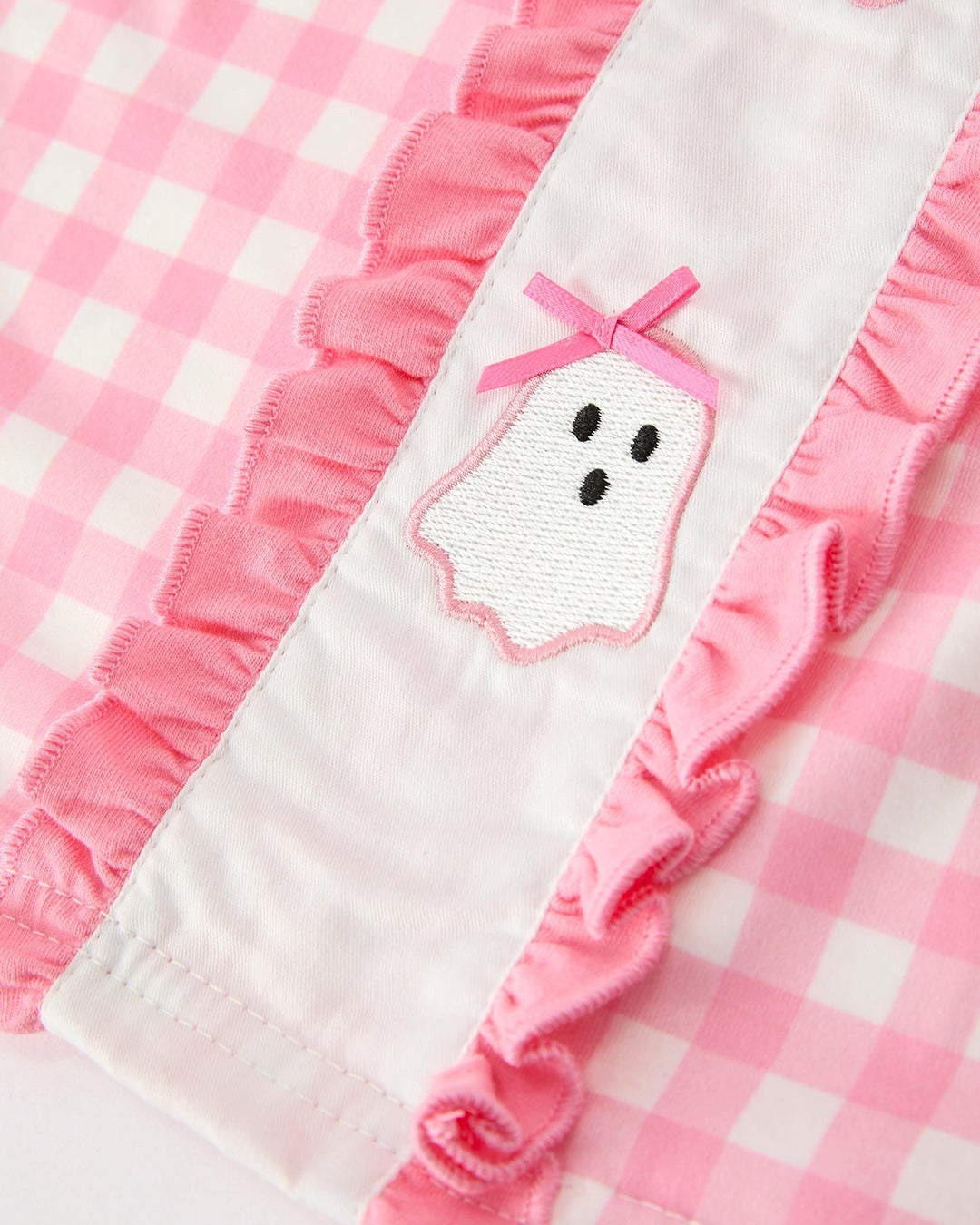 Girls pink gingham dress close-up of ghost face applique on front