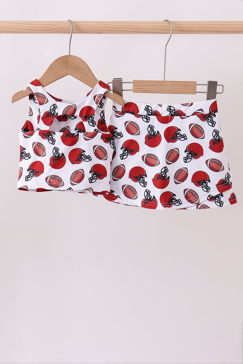 Girls outfit with football pattern on a hanger against a white background