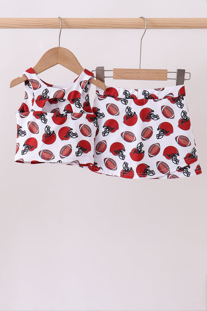 Girls outfit with football pattern on a hanger against a white background