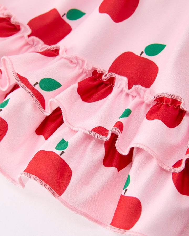 Pink fabric with red apple pattern