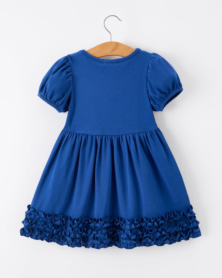 Blue dress with ruffled hem on a hanger against a white background
