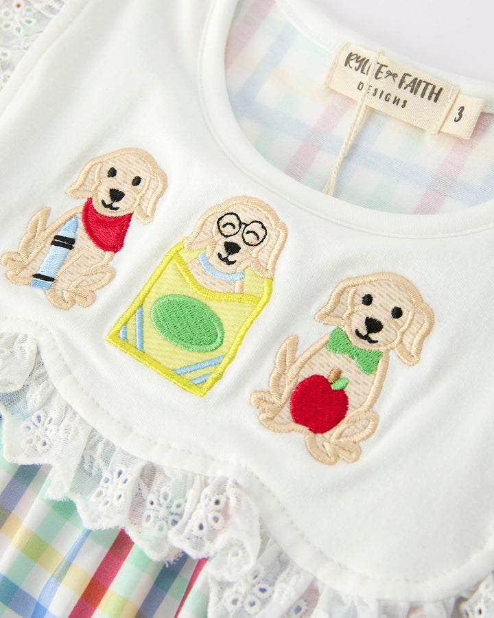 White dress with embroidered dog designs on a colorful background