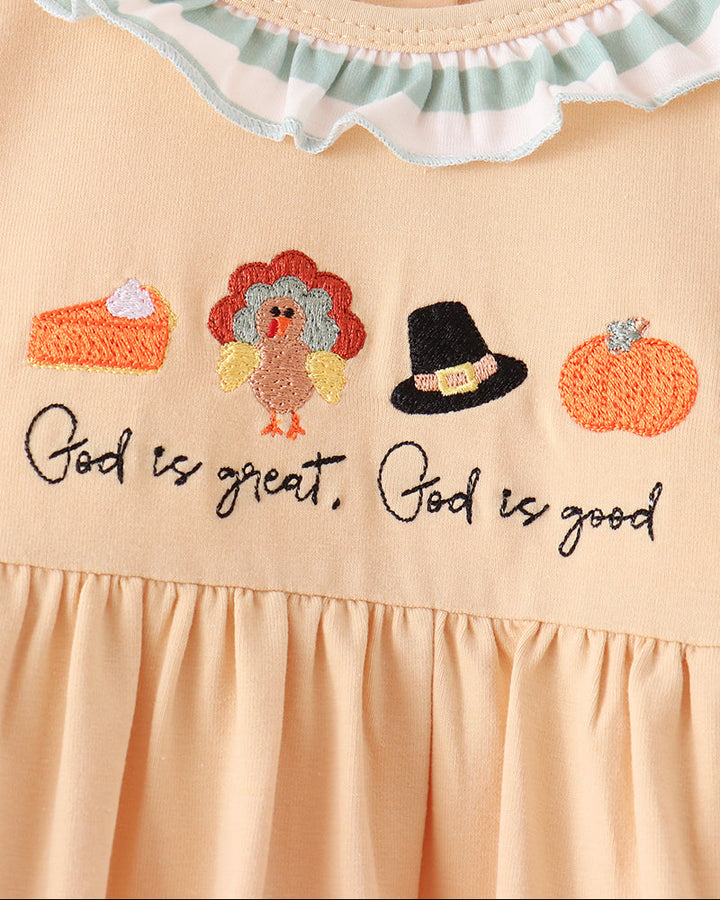 Beige yoke with colorful embroidery, cursive text, and ruffled neckline