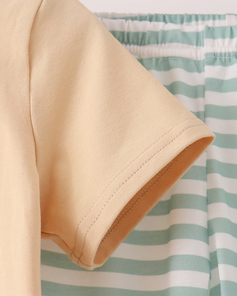 Beige T-shirt sleeve and hem with mint-and-white striped pants, elastic waistband visible