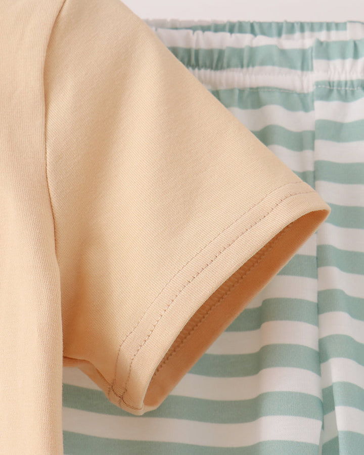 Beige T-shirt sleeve and hem with mint-and-white striped pants, elastic waistband visible
